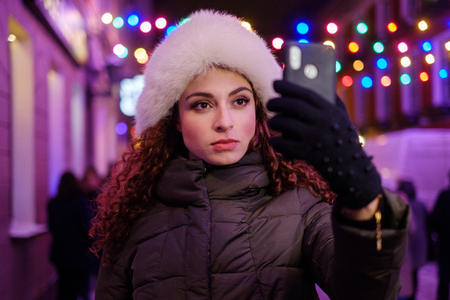 Woman making selfie a cold winter eveningの写真素材