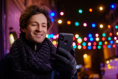 Man making selfie on a cold winter eveningの写真素材