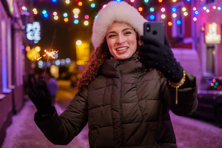 Woman making selfie a cold winter eveningの写真素材