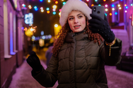 Woman making selfie a cold winter eveningの写真素材