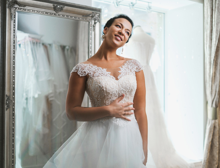 Beautifu bride choosing wedding dress in a wedding salonの写真素材