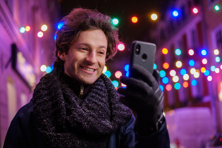 Man making selfie on a cold winter eveningの写真素材