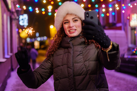 Woman making selfie a cold winter eveningの写真素材