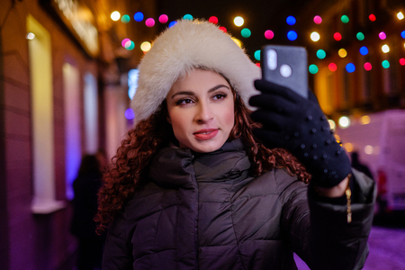 Woman making selfie a cold winter eveningの写真素材