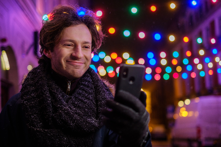 Man making selfie on a cold winter eveningの写真素材