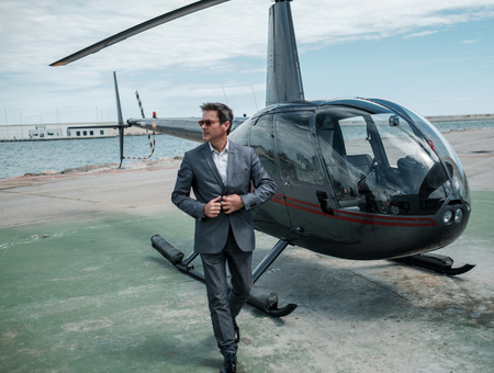 Businessman standing near private helicopterの写真素材