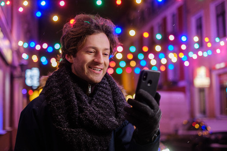 Man making selfie on a cold winter eveningの写真素材
