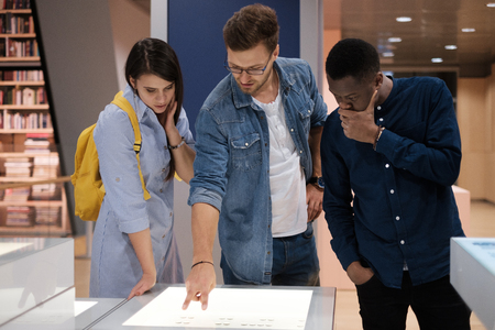 Multicultural group of students in a public libraryの写真素材