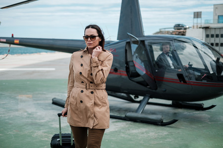 Business woman near a private helicopterの写真素材