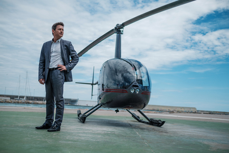 Businessman standing near private helicopterの写真素材