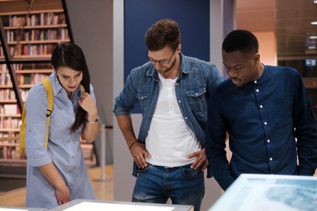 Multicultural group of students in a public libraryの写真素材
