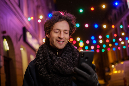 Man making selfie on a cold winter eveningの写真素材