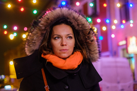 Woman outdoor on a cold winter eveningの写真素材
