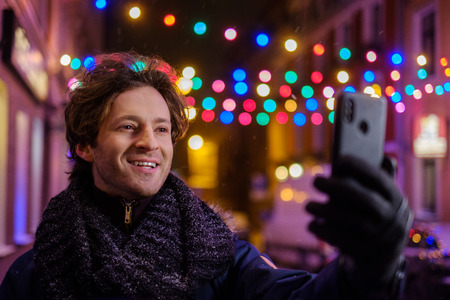 Man making selfie on a cold winter eveningの写真素材