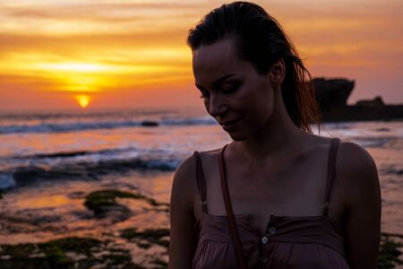 Woman against Pura Tanah Lot temple , Baliの写真素材