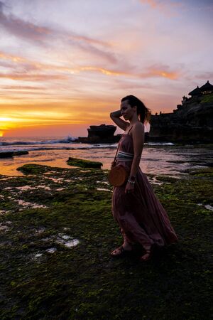 Woman against Pura Tanah Lot temple , Baliの写真素材