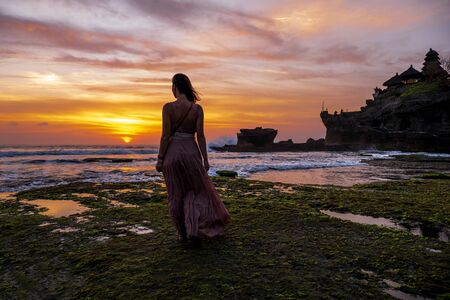 Woman against Pura Tanah Lot temple , Baliの写真素材