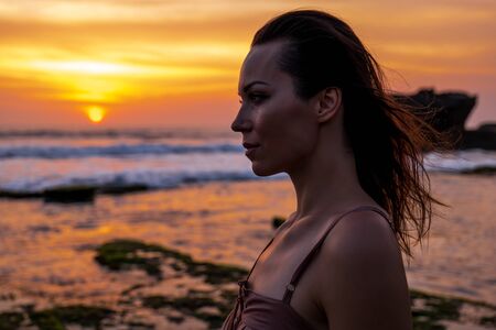 Woman against Pura Tanah Lot temple , Baliの写真素材