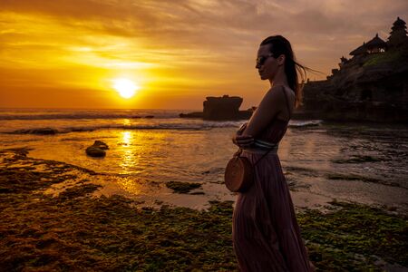 Woman against Pura Tanah Lot temple , Baliの写真素材