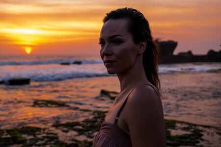 Woman against Pura Tanah Lot temple , Baliの写真素材