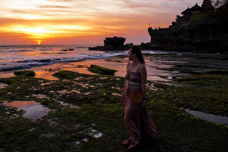 Woman against Pura Tanah Lot temple , Baliの写真素材