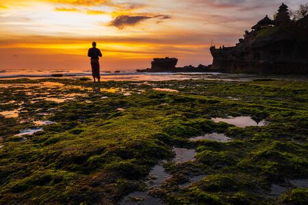 Monk against Pura Tanah Lot temple , Baliの写真素材