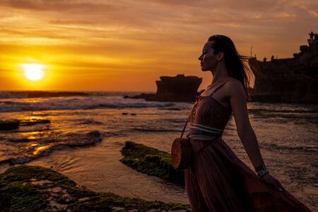 Woman against Pura Tanah Lot temple , Baliの写真素材