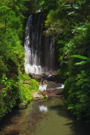 Woman near Labuhan Kebo Waterfall located in Munduk, Bali.