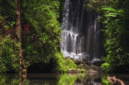 Woman near Labuhan Kebo Waterfall located in Munduk, Bali