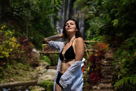 Woman near Labuhan Kebo Waterfall located in Munduk, Baliの写真素材