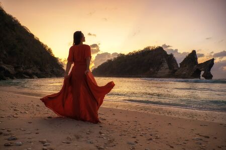 Woman at Atuh beach at Nusa Penida Island, Bali, Indonesiaの写真素材