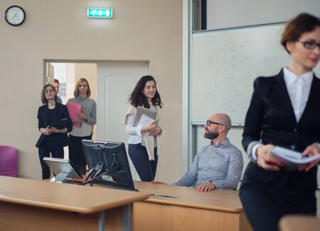 Lecturer and multinational group of students in an auditoriumの写真素材