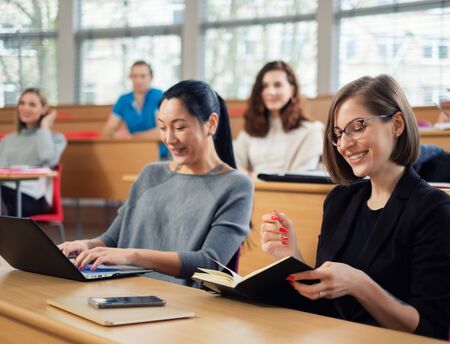 Lecturer and multinational group of students in an auditorium