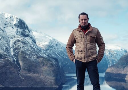 Man at Stegastein viewpoint above Aurlandsfjord in Norwayの写真素材