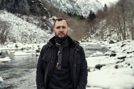 Man against river running from Stalheimsfossen waterfall in Naeroydalen valley, Norwayの写真素材
