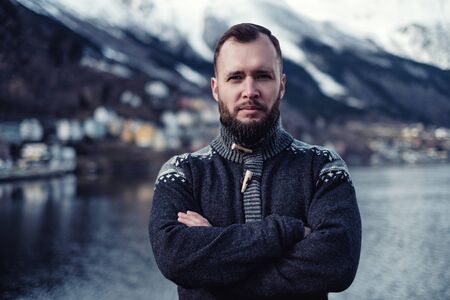 Man in front of beautiful town of Odda, Norwayの写真素材