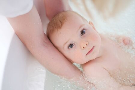 Baby boy getting an aquatic massageの写真素材