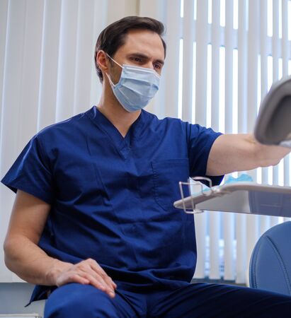 Doctor wearing protective mask in a hospitalの写真素材