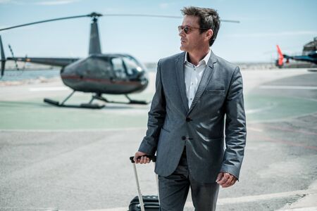 Businessman standing near private helicopterの写真素材