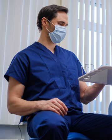 Doctor wearing protective mask in a hospitalの写真素材