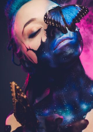 Beautiful woman with blue hair and butterflyの写真素材