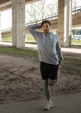 Man doing street workout alone in a cityの写真素材
