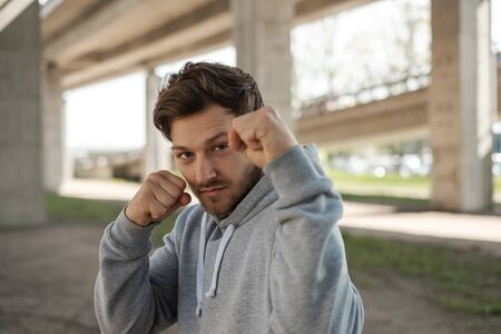 Man doing street workout alone in a cityの写真素材