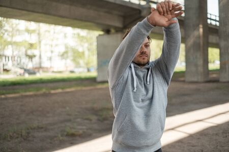 Man doing street workout alone in a cityの写真素材