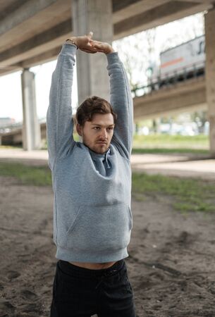 Man doing street workout alone in a cityの写真素材