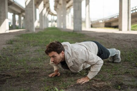 Man doing push-ups during street workoutの写真素材