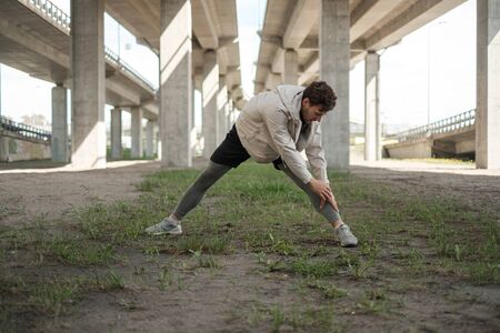 Man doing street workout alone in a cityの写真素材