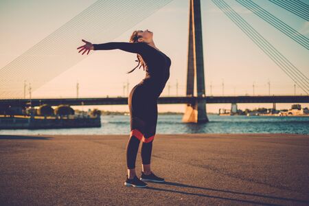 Body positive woman doing fitness exercise outdoorの写真素材