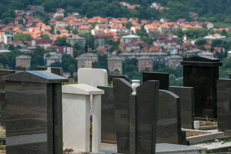 Part of the local Spooky cemetery with the small suburb in the background. The proximity of life and death.の写真素材