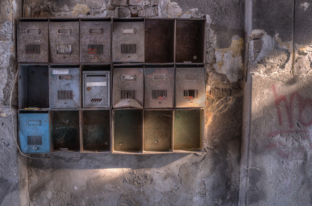 Old rusty Mailboxes in the hallway of the old and abandoned building